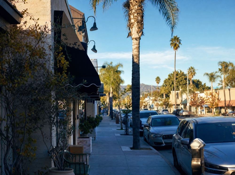 A sunlit neighborhood commercial street in the San Fernando Valley